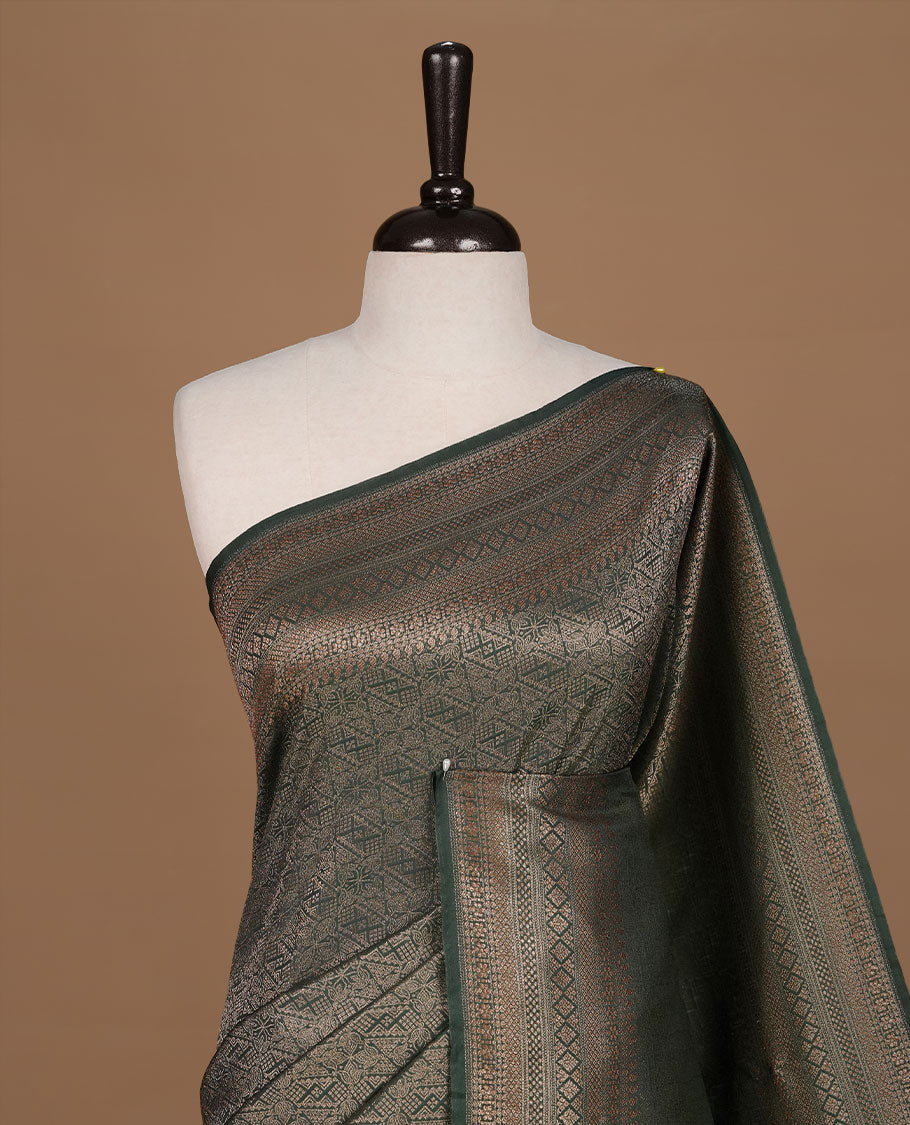 Green colour semi banaras katan saree featuring Gold zari Pattern across body, complemented by self colour with zari border, paired with matching blouse piece.