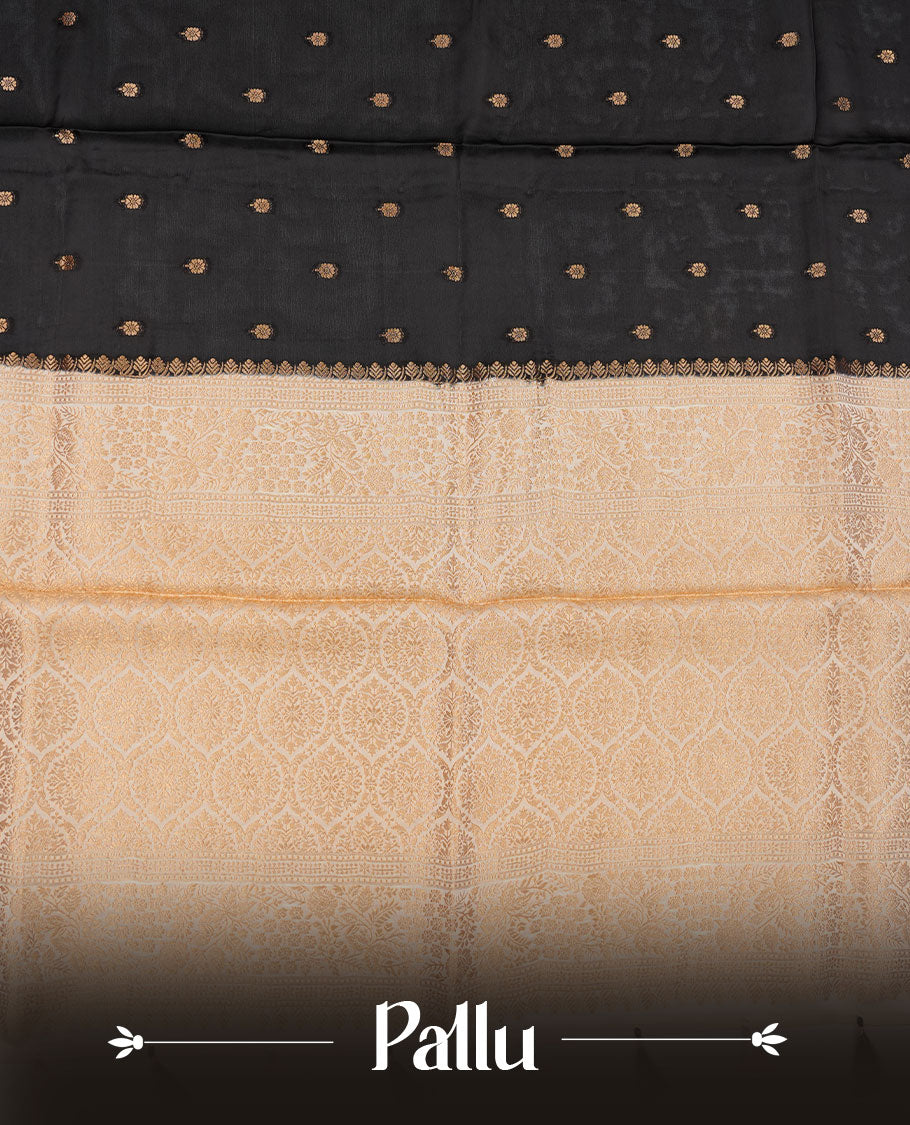 Black colour banaras satin crepe saree featuring gold zari motifs on body, with contrast cream colour border with gold zari pattern and paired with matching blouse.