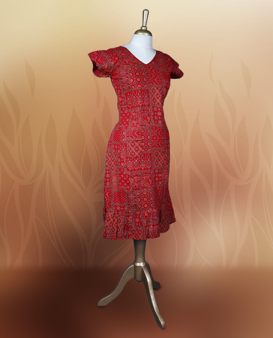 Red colour nightwear with traditional patch style prints in black and white, Features a V neck, puff sleeves, and a ruffled flared hem, A stylish pick for festive occasions, casual wear, or ethnic flair.