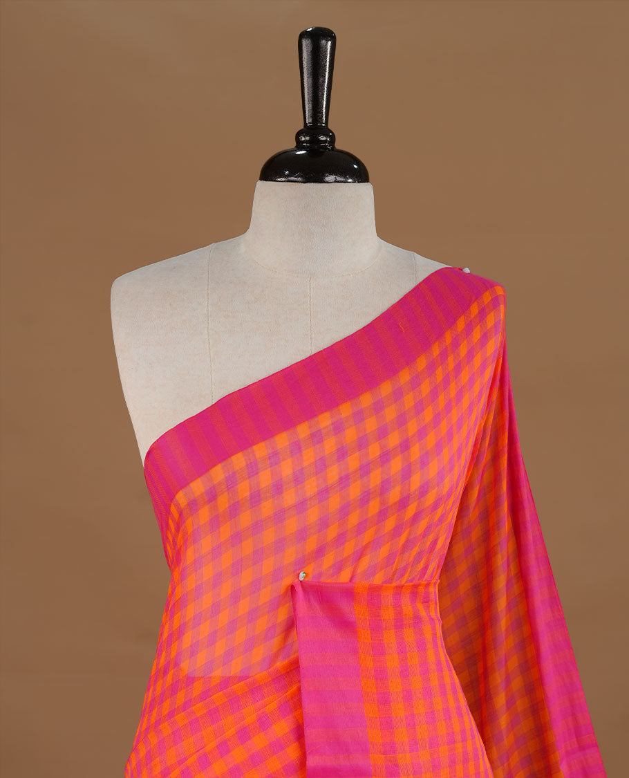 Orange and Pink colour Mul Cotton saree featuring a classic Big check pattern on the body, accented with tassels for added charm. Comes without a blouse piece.