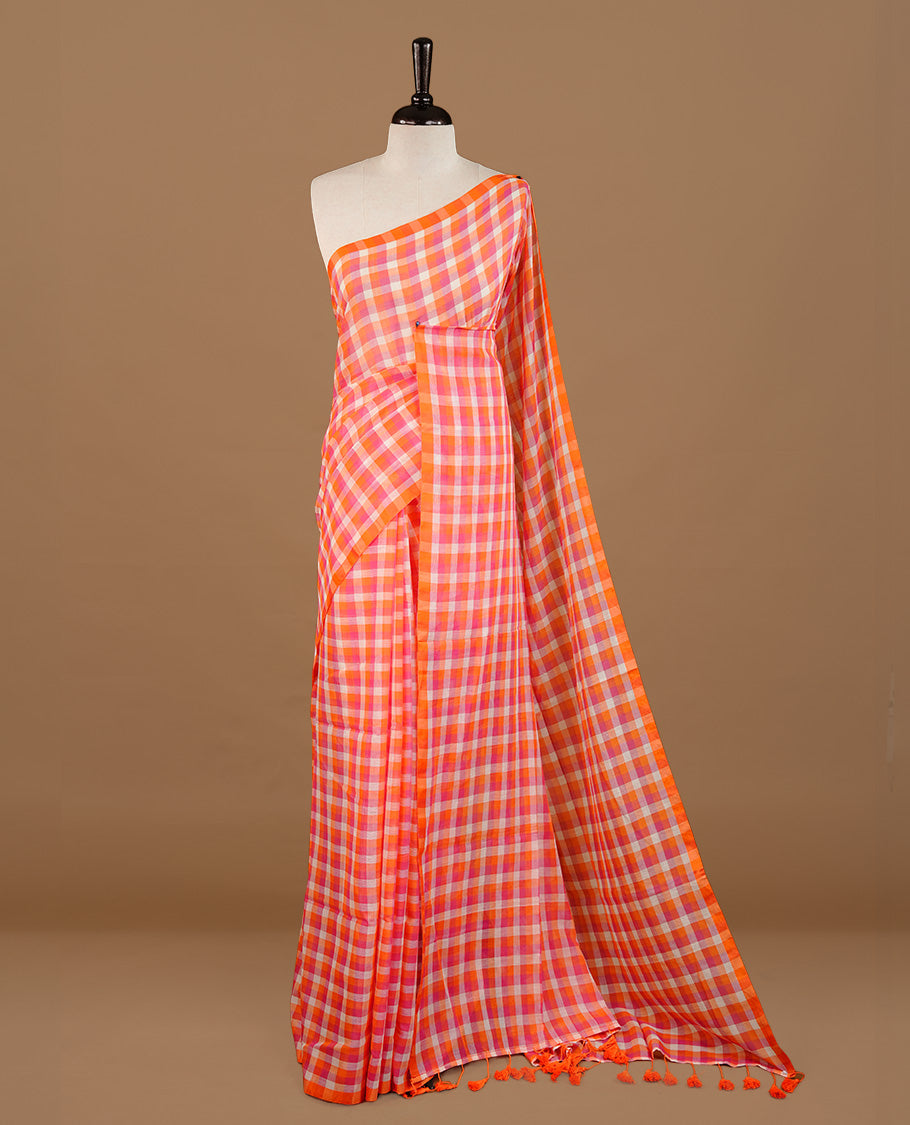 Orange, Pink and White colour Mul Cotton saree featuring a classic Big check pattern on the body, accented with tassels for added charm. Comes without a blouse piece.
