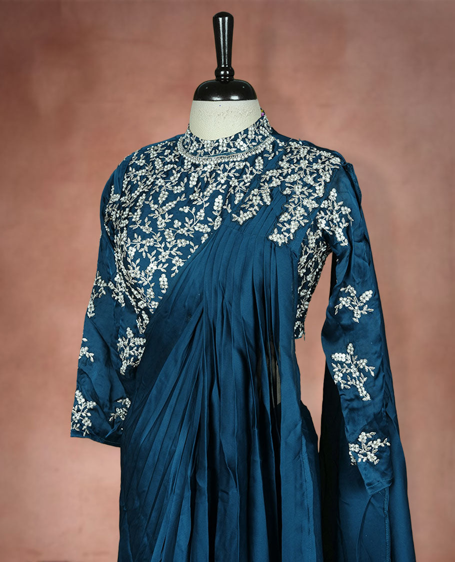 Deep teal colour ready to wear saree Fearturing intricate silver embroidery on the pallu, paired with a beats and thread embroidered matching blouse.
