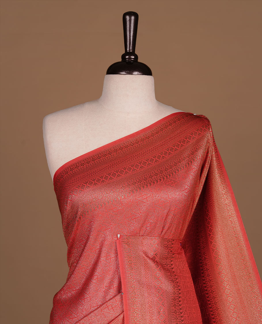 Red colour semi banaras katan saree featuring Gold zari Pattern across body, complemented by self colour with zari border, paired with matching blouse piece.