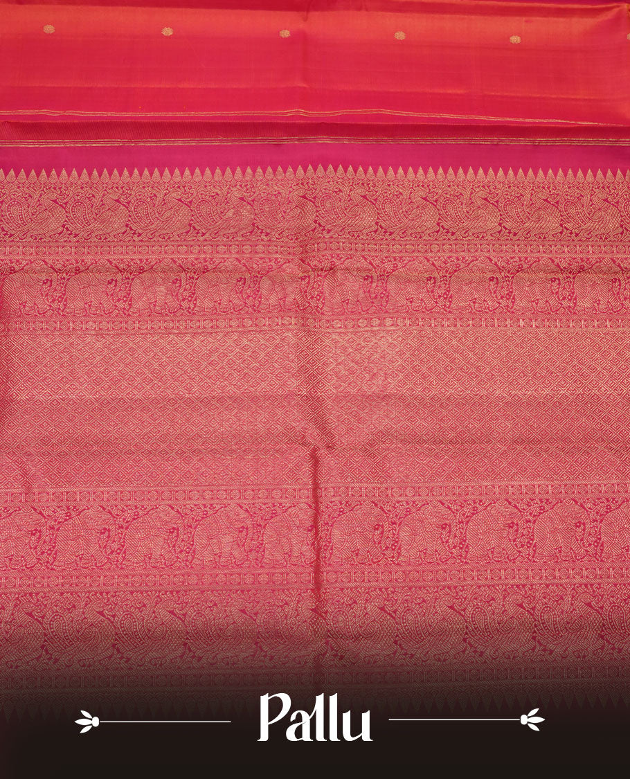Orange and pink double shade pure traditional Kancheepuram silk saree adorned with elegant zari peacock and chakra motifs on the body, complemented by a simple contrast zari woven border, paired with a matching blouse piece.