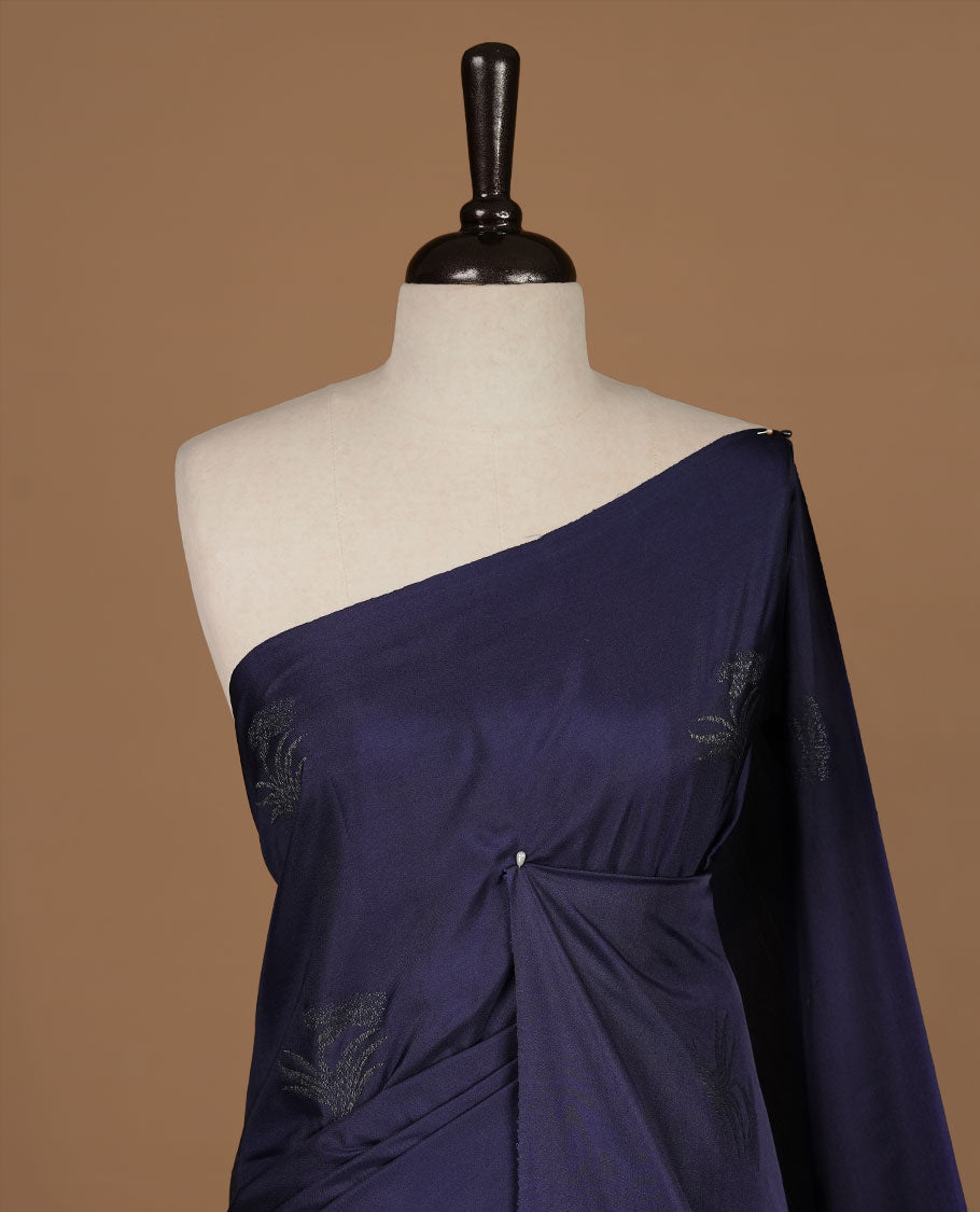 Navy Blue soft silk saree features a sleek borderless design with intricate antique zari motifs, flowing into a seamless self colored pallu and a matching blouse piece.