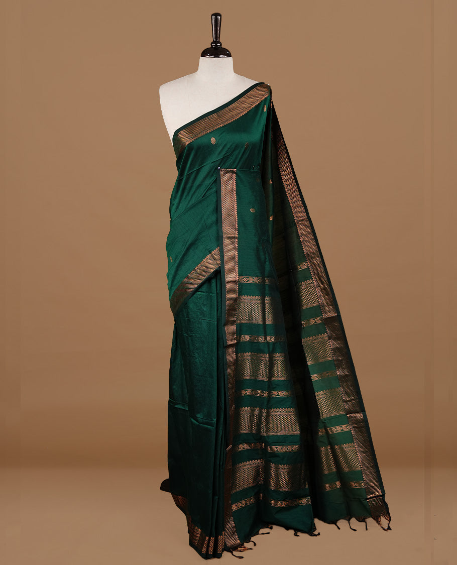Green colour kalyani cotton saree featuring gold zari motifs on body, highlighting self colour with Antique gold zari border, paired with matching blouse piece.