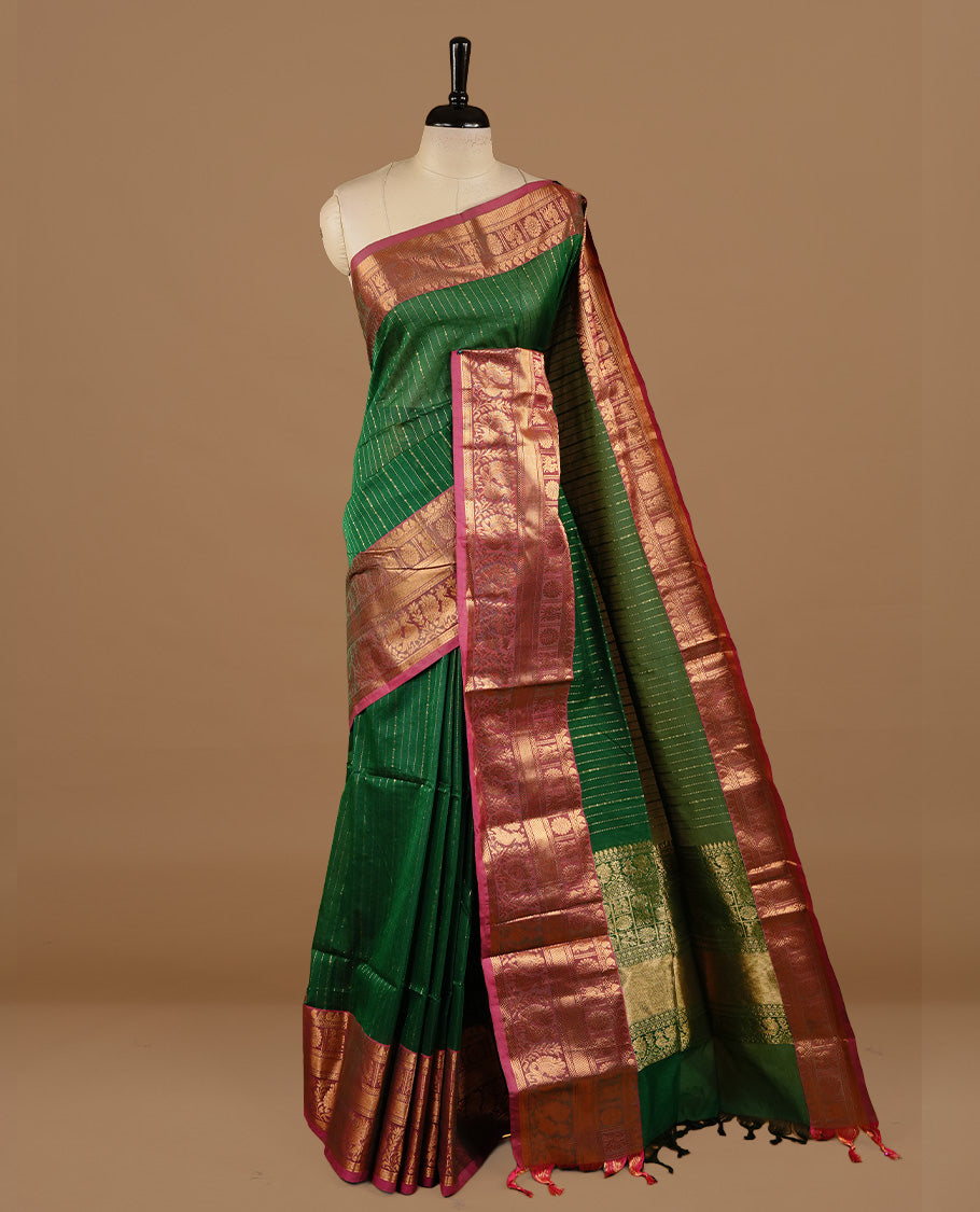 Green colour chettinad cotton saree featuring gold zari stripes on body, complemented by magenta colour with zari border, paired with matching blouse piece.
