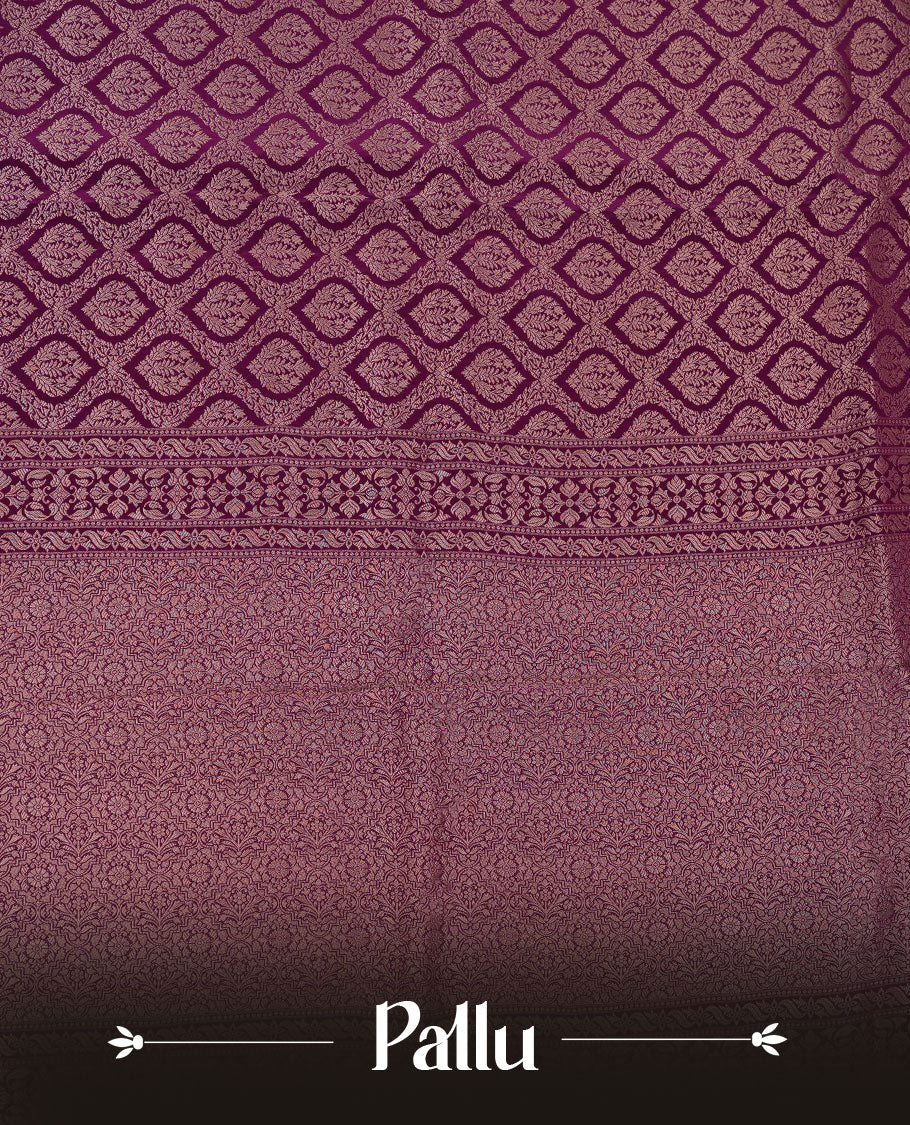 Grape colour banaras satin crepe saree featuring gold zari pattern across body, with self colour border with gold zari pattern and paired with matching blouse.