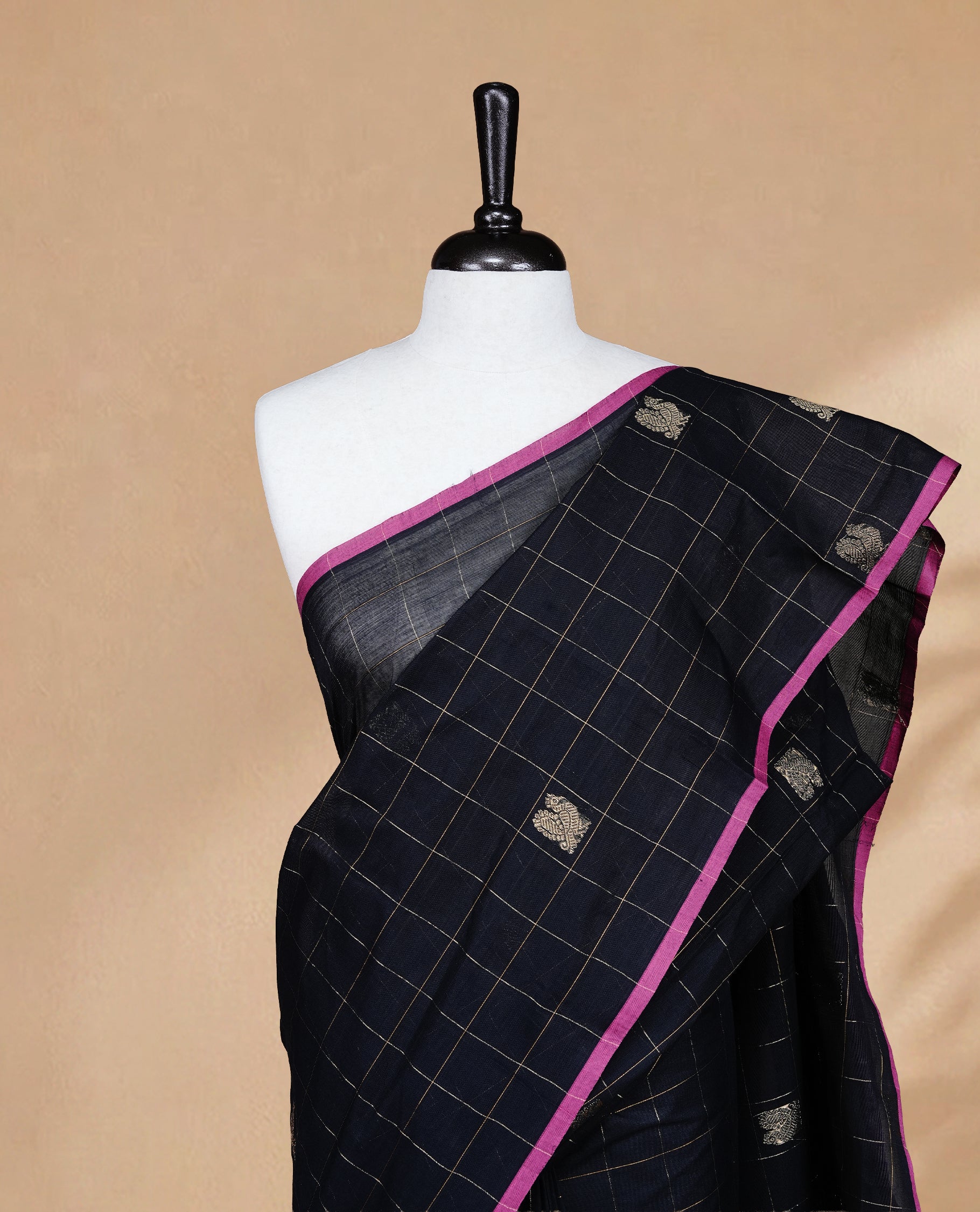 Black colour chettinad cotton saree featuring Gold zari check with Peacock motifs on body, complemented by Magenta colour piping border, paired with matching blouse.