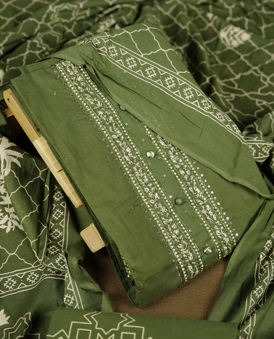 Dark green colour churidar set with stone and thread embroidery and detailing, paired with matching pant and dupatta.