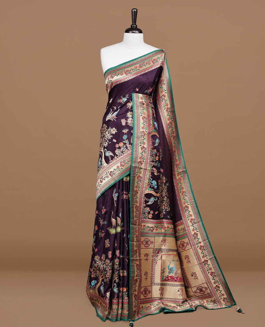 Deep purple colour Pashmina silk saree features an all over forest body, a contrast cream & green floral kodi border and pallu, and a matching unstitched blouse.