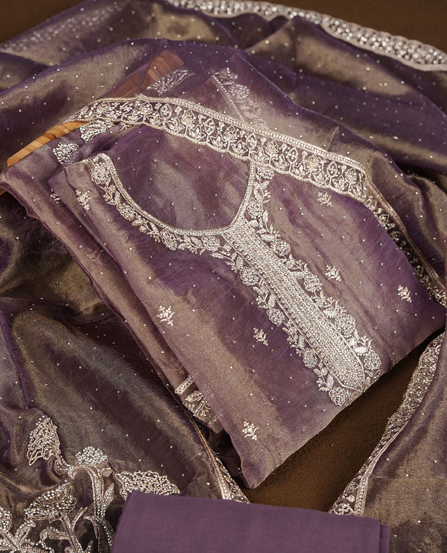 Purple and gold double shade colour churidar set with stone and thread embroidery and detailing, paired with matching pant and dupatta.