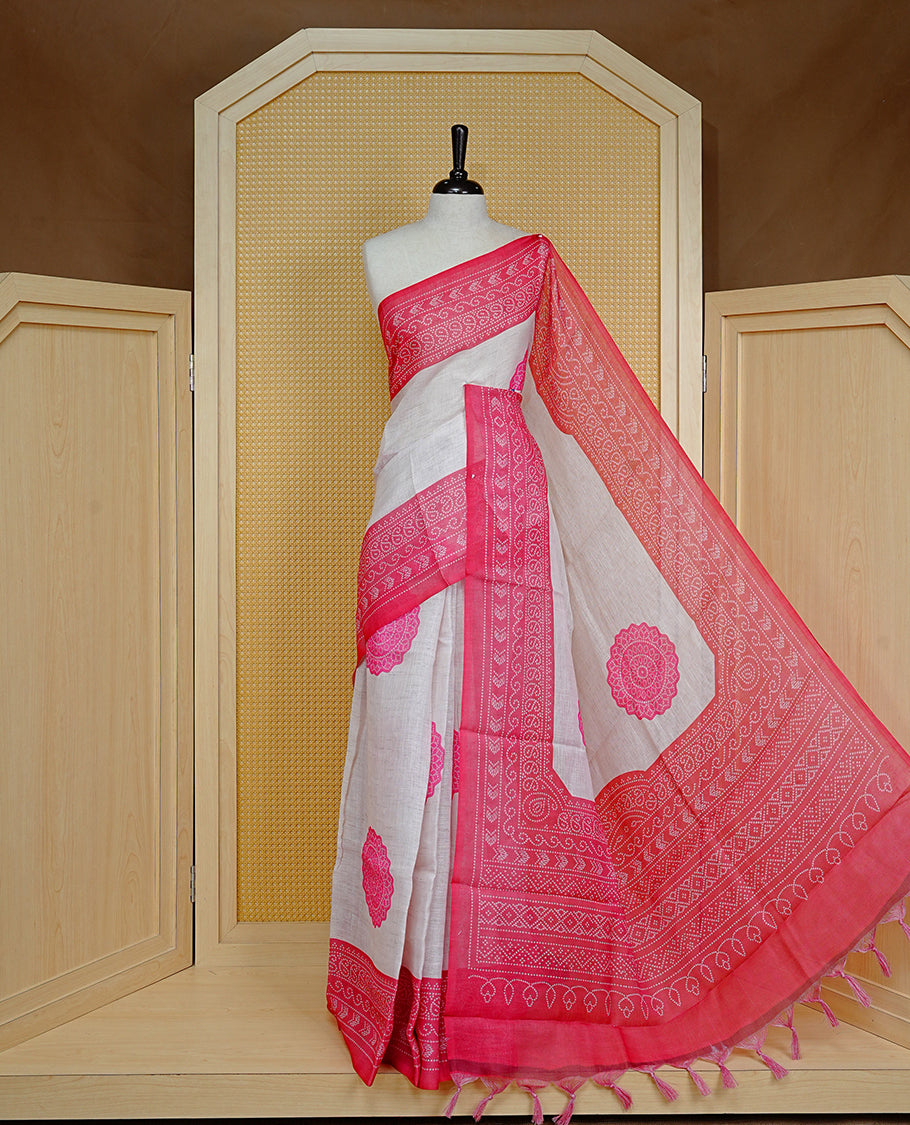 Cream colour semi linen saree featuring Pink Ajrakh pattern print on body, complemented by contrast Red colour with same pattern print border, comes with matching blouse piece.