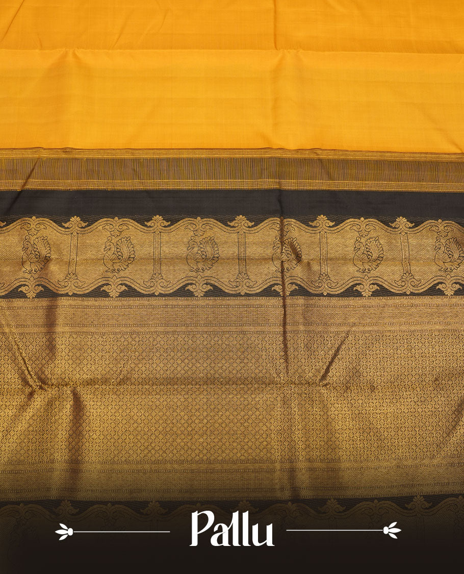 Mustard yellow colour pure traditional Kancheepuram silk saree featuring elegant contrast black zari traditional borders, beautifully paired with a matching blouse piece.