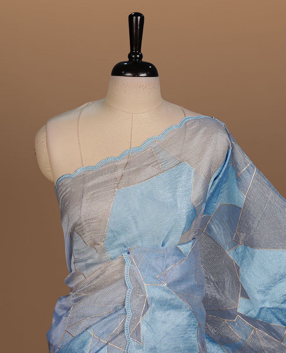 Blue colour Organza designer saree featuring a thread geometric pattern across the body, enhanced with a piping border and cut beats work on matching blouse piece.