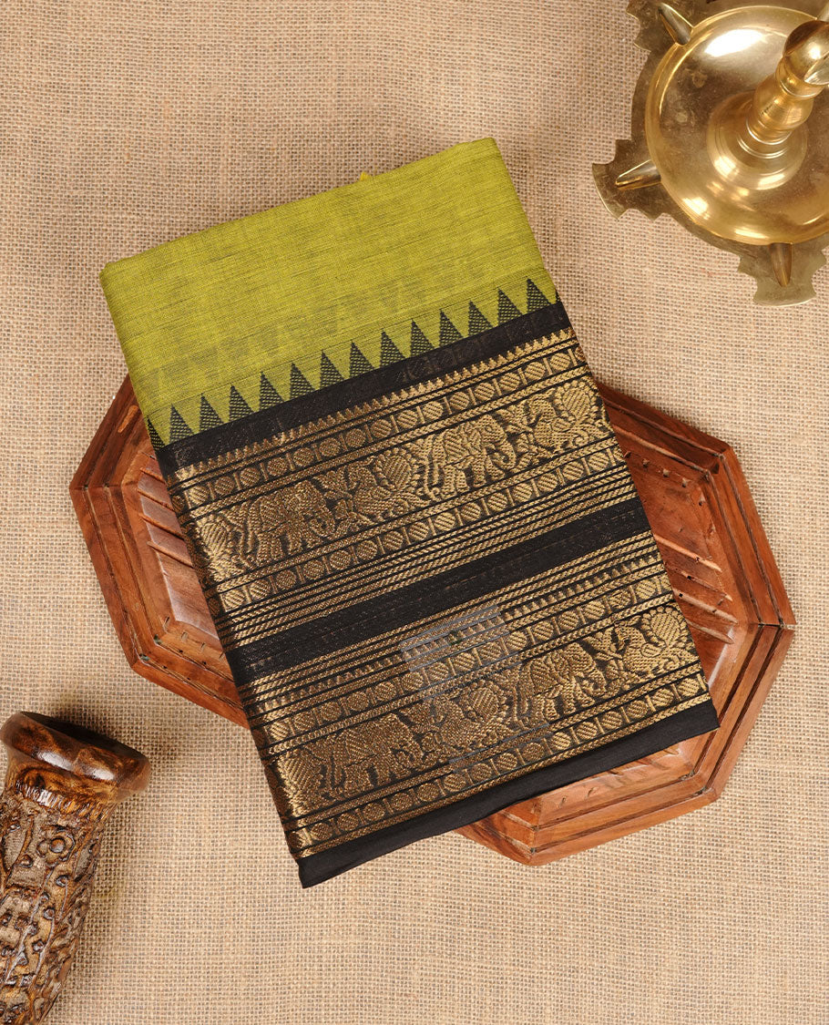 Lemon green colour chettinad cotton saree featuring plain body, contrast black colour with traditional gold zari border without blouse.