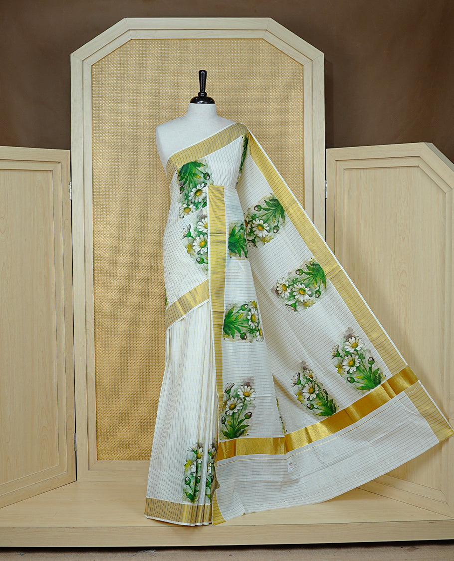Cream Colour Kerala Saree Featuring A Light Gold Zari Pattern And Floral Prints On The Body, Enriched By A Traditional Zari Border And Pallu, Paired With A Matching Blouse Piece