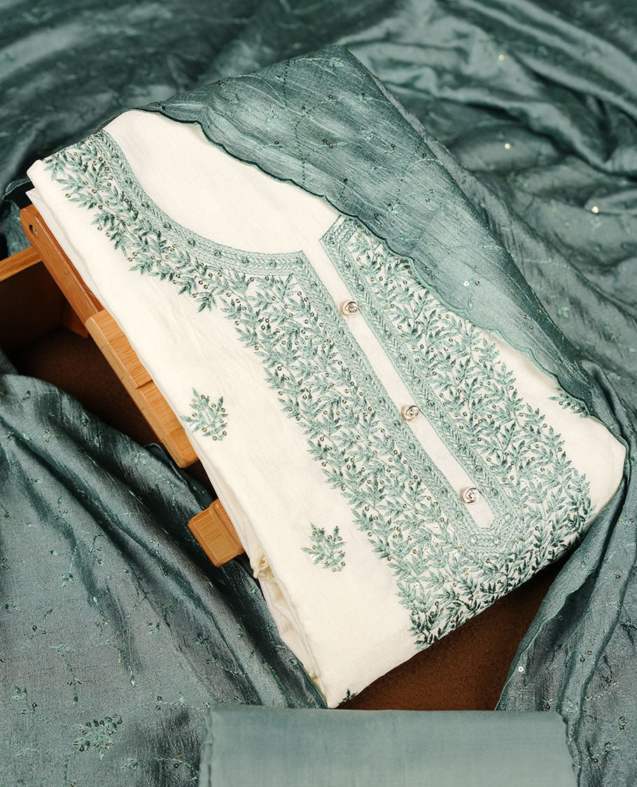 Ivory colour churidar material with teal colour thread embroidery on the front panel, paired with a matching dupatta and bottom.