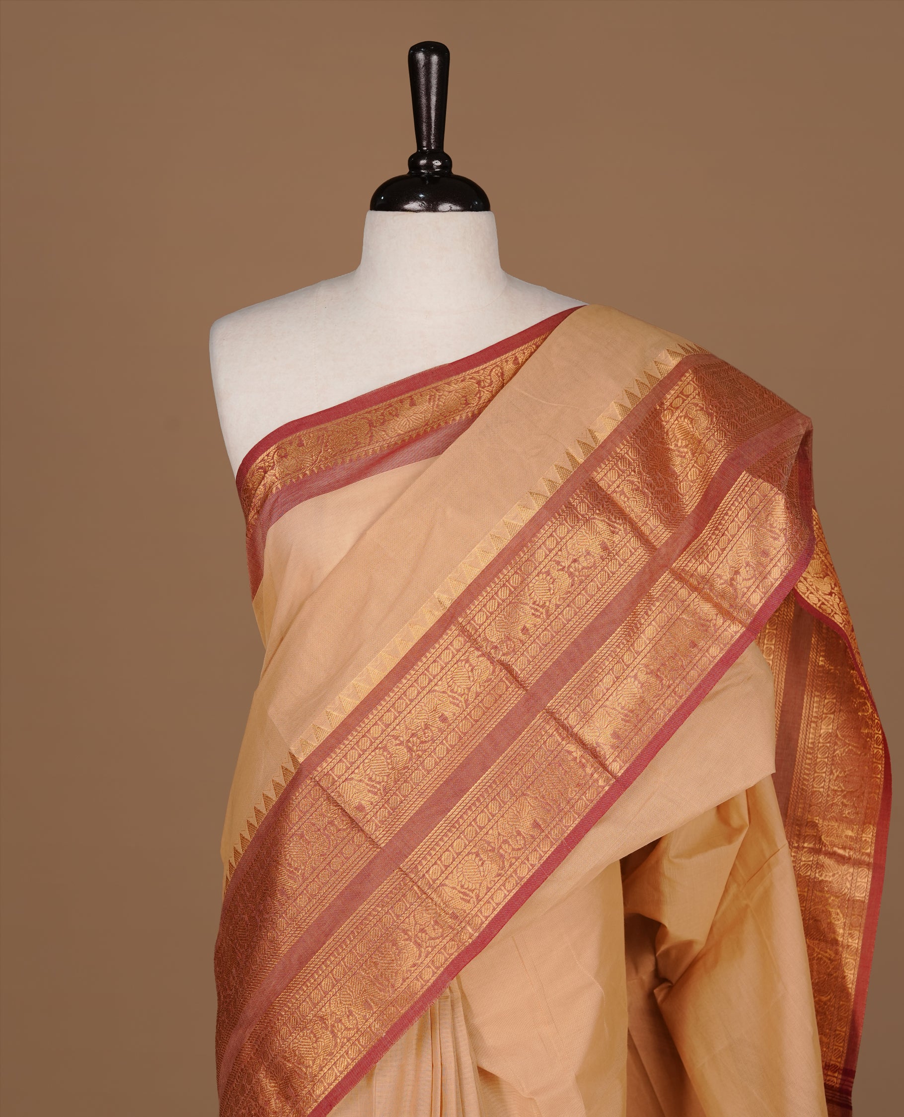 Sandalwood Colour chettinad cotton saree featuring Elegant plain body, complemented by contrast Brick red colour with gold zari border, paired with matching blouse.