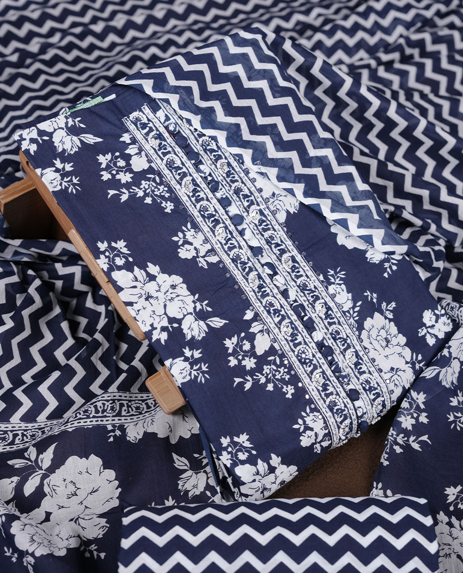Blue colour churidar set with white floral print, stone and thread embroidery and detailing, paired with matching pant and dupatta.