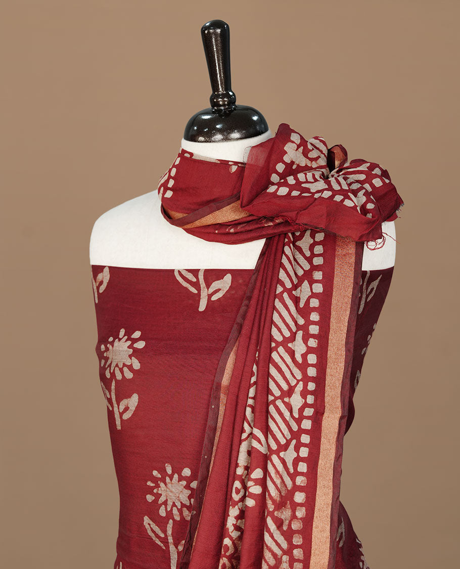 Maroon colour churidhar material featuring cream colour floral print on body, paired with matching bottom and Dupatta.