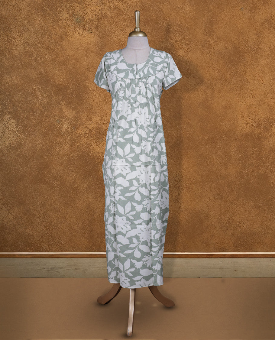Dark sea green colour NStyle nighty featuring Offwhite Leaf patterns, a Round neckline and thread border, short sleeves, and a full ankle-length design.