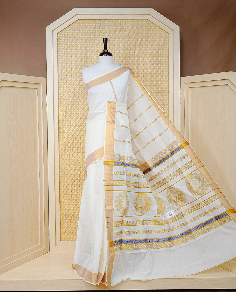 Cream Colour Cotton Kerala Saree Featuring an Elegant Plain Body, a Classy Gold Zari Border, and a Traditional Gold Zari Pallu with Blue Accents, Paired with a Matching Blouse Piece.