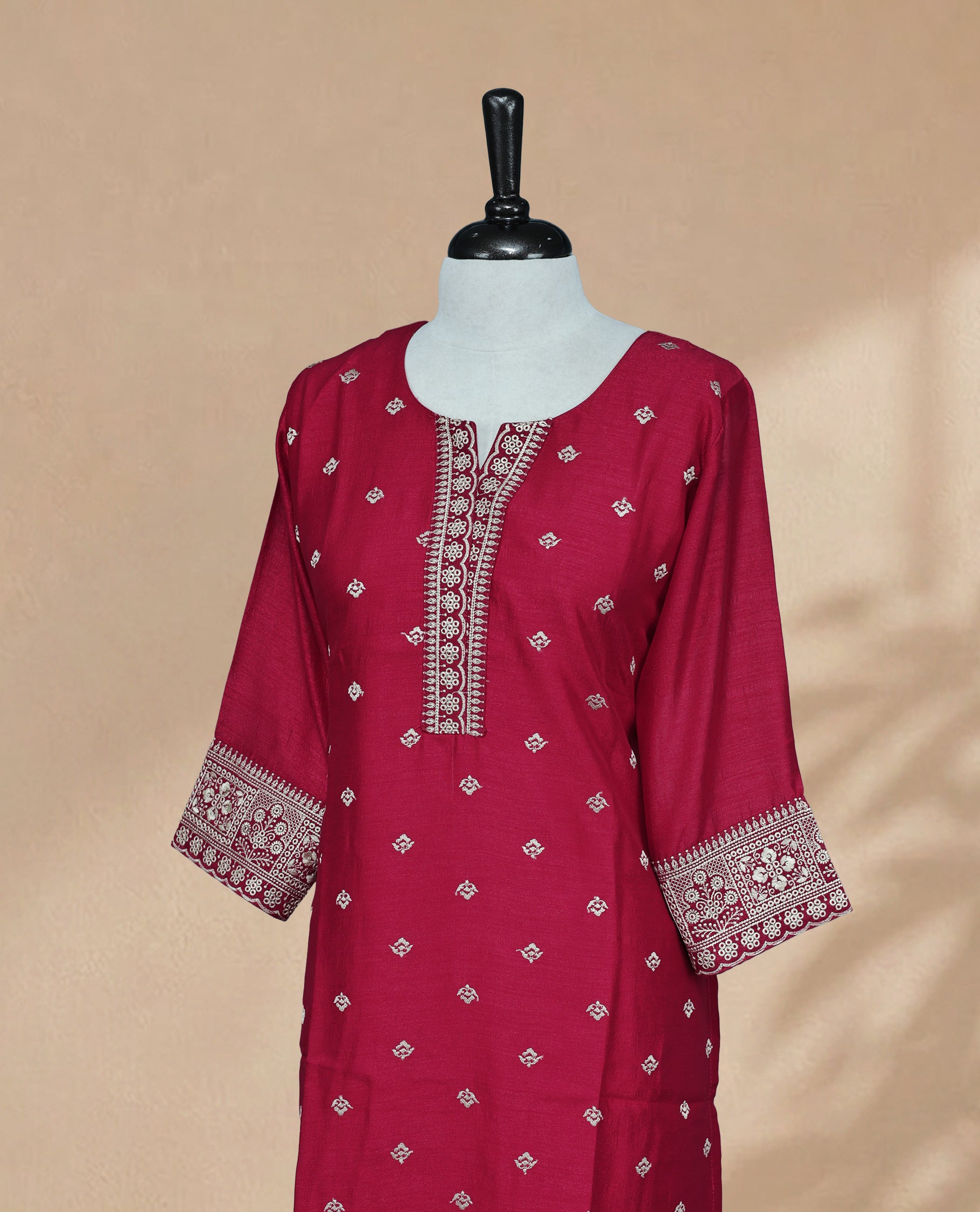 Red Kurti featuring threadwork across the body, a U-shaped neckline adorned with threadwork, and 3/4 sleeves with matching threadwork.