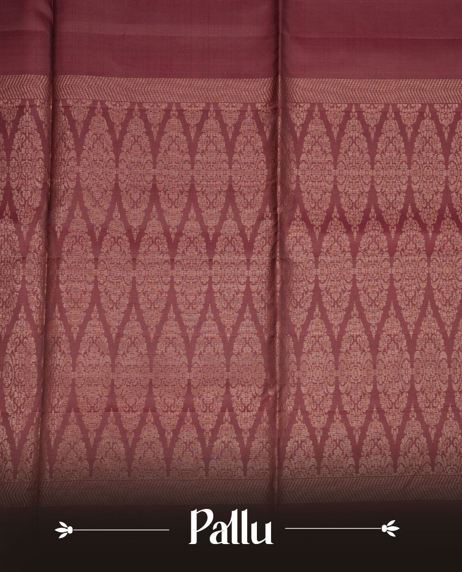Brown colour soft silk saree featuring gold zari motifs on body, complemented by self colour with traditional border with tassel at pallu, paired with matching blouse piece.