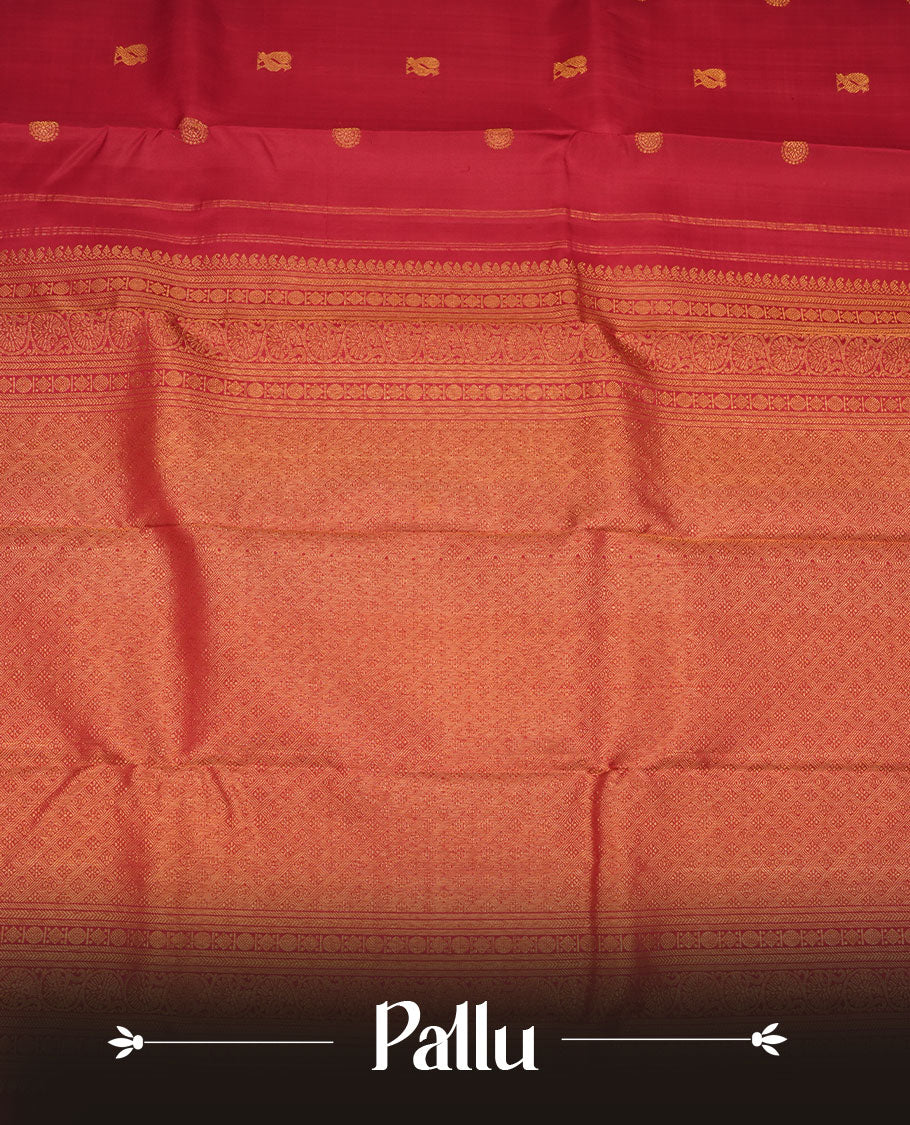 Dark red colour pure traditional Kancheepuram silk saree adorned with elegant zari peacock and chakra motifs on the body, complemented by a simple Gold Zari zari woven border, paired with a matching blouse piece.