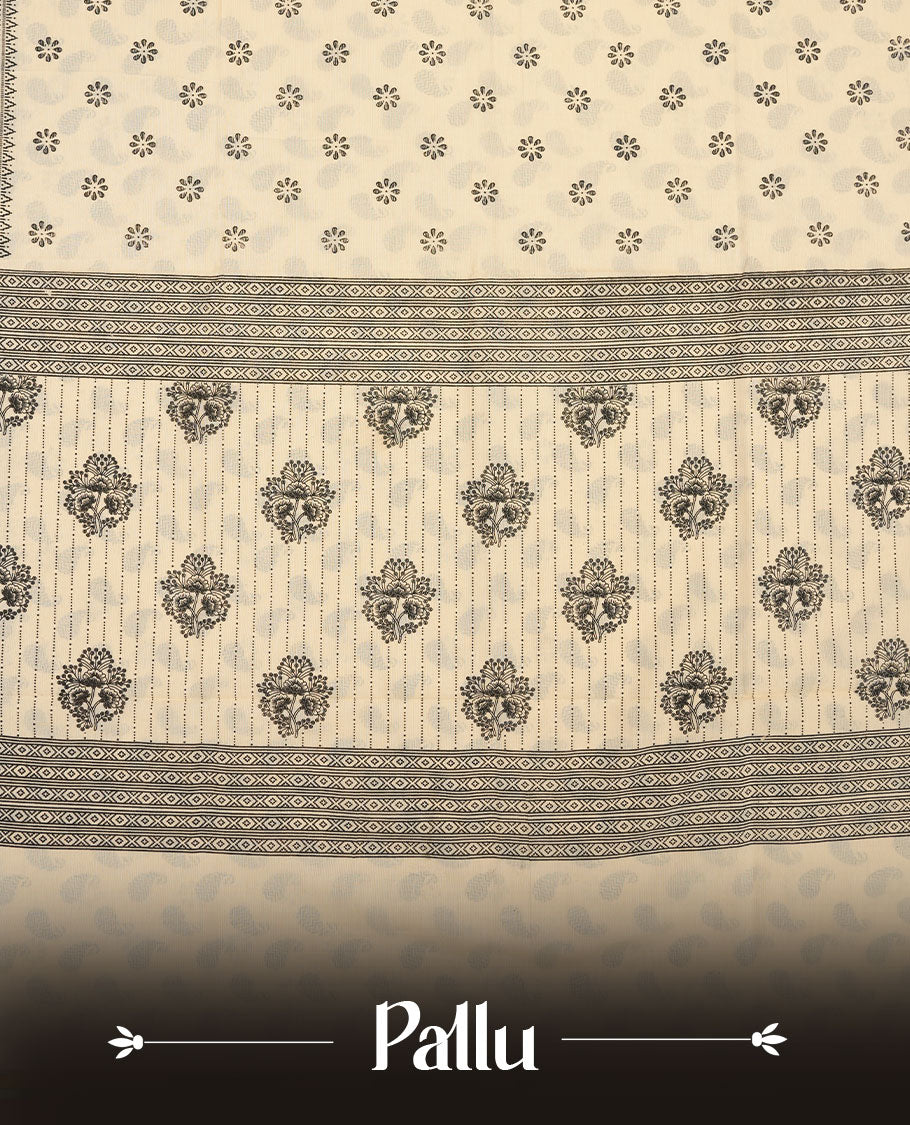 Cream colour poly cotton saree with black floral butti motifs on the body, paired with a matching pallu featuring black ornate floral jaal and stripes on the border, and a coordinated all‑over black paisley printed blouse piece.