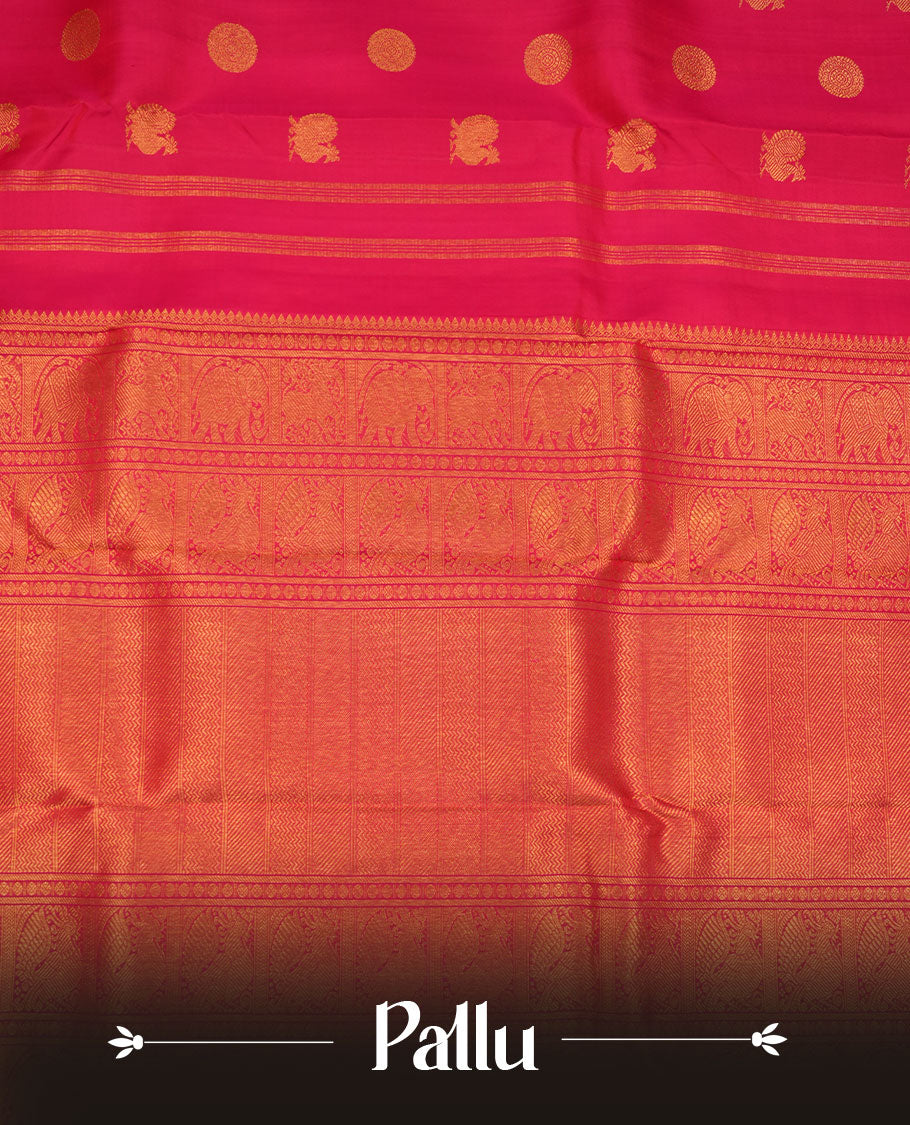 Rani pink colour pure traditional Kancheepuram silk saree adorned with gold zari peacock & chakra motifs across the body, featuring elegant traditional borders, beautifully paired with a matching blouse piece.