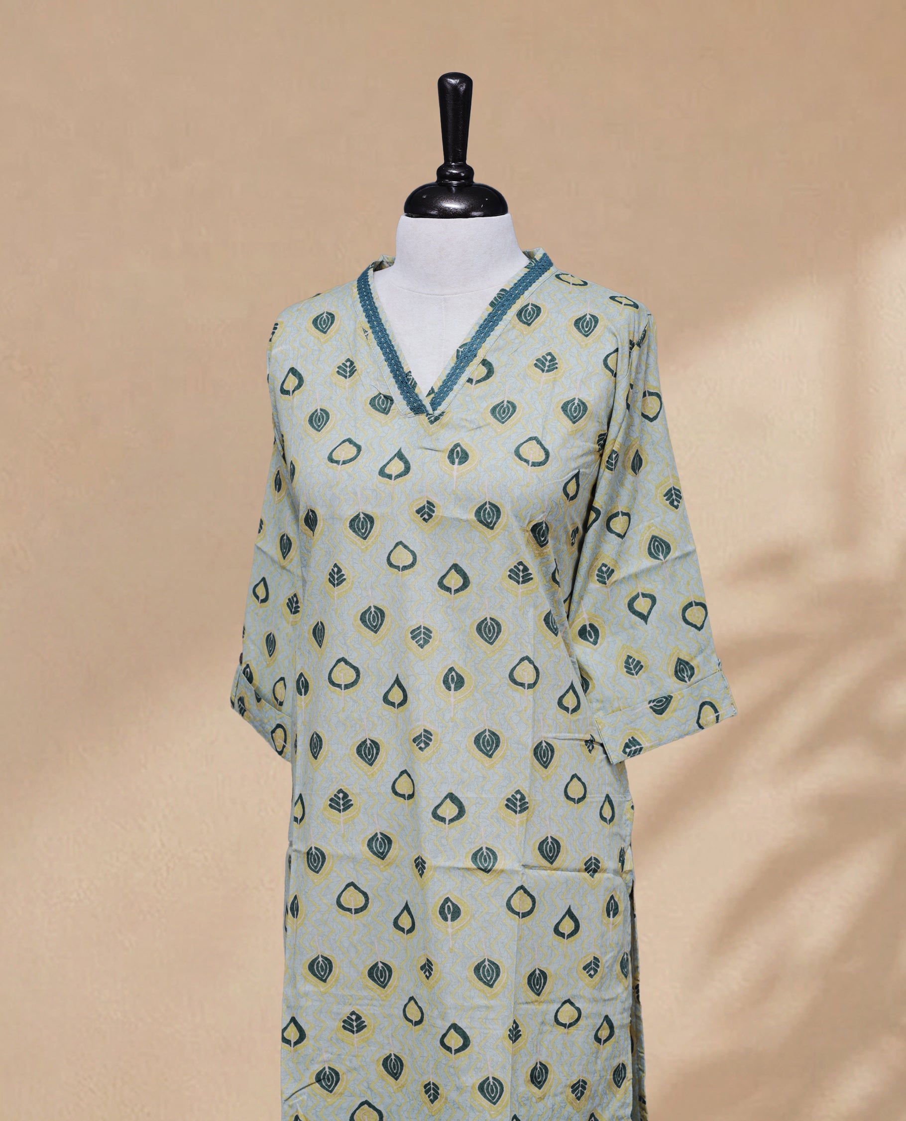 Sea Salt Colour kurti featuring a classic V-shaped Thread Pattern neckline, Green & Yellow Leaf Prints on the body, and sleeves.