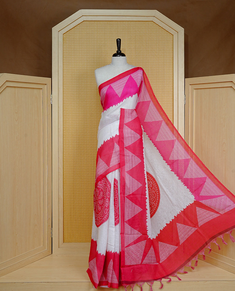 Cream colour semi linen saree featuring red Ajrakh pattern print on body, complemented by contrast Pink colour with same pattern print Red border, comes with matching blouse piece.