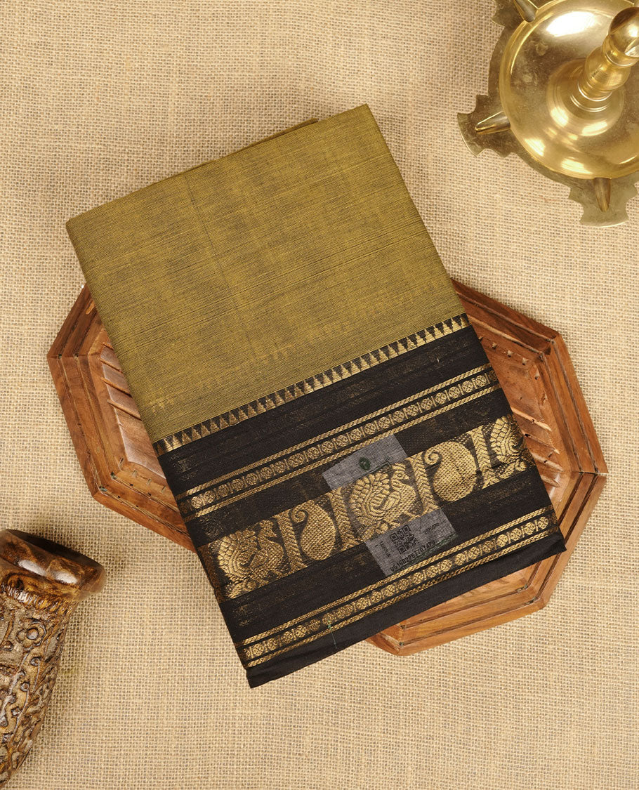 Mehandi colour chettinad cotton saree featuring plain body, contrast black colour with traditional gold zari border paired with matching blouse.