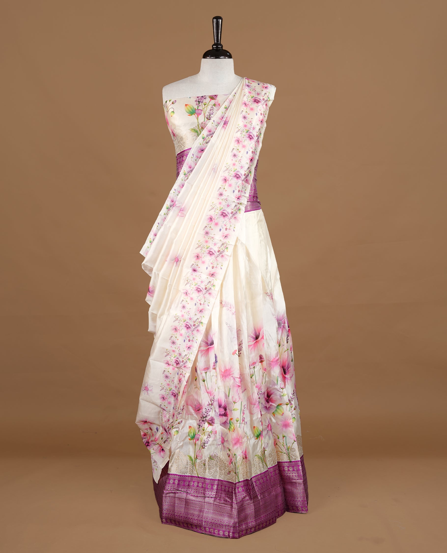 Off white colour semi stitched half saree featuring elegant multicolour floral prints, paired with a light gold border and matching printed dupatta ,paired with matching blouse piece.