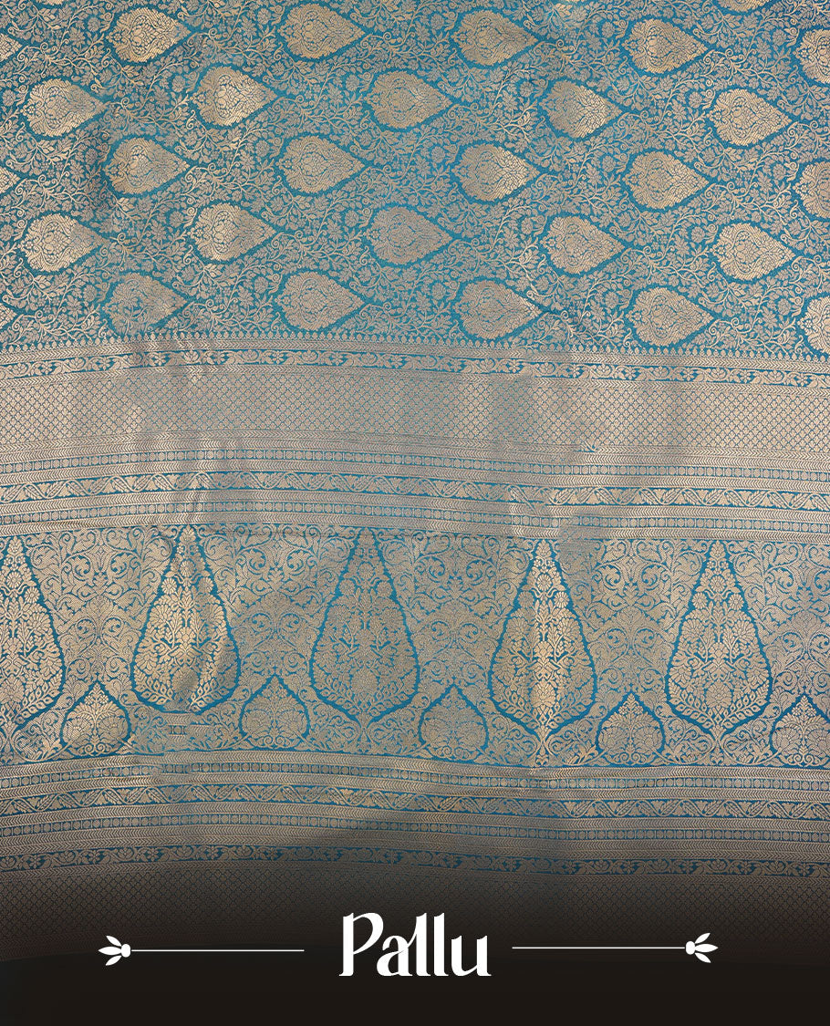 Teal blue colour semi silk brocade saree featuring intricate Gold Floral kodi patterns across the body, complemented by a Self colour woven border and pallu, paired with a matching blouse.