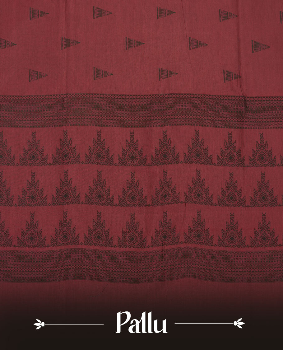 Dark red colour poly cotton saree with black temple motifs on the body, paired with a matching with black woven traditional border, and a coordinated all‑over geometric printed blouse piece.