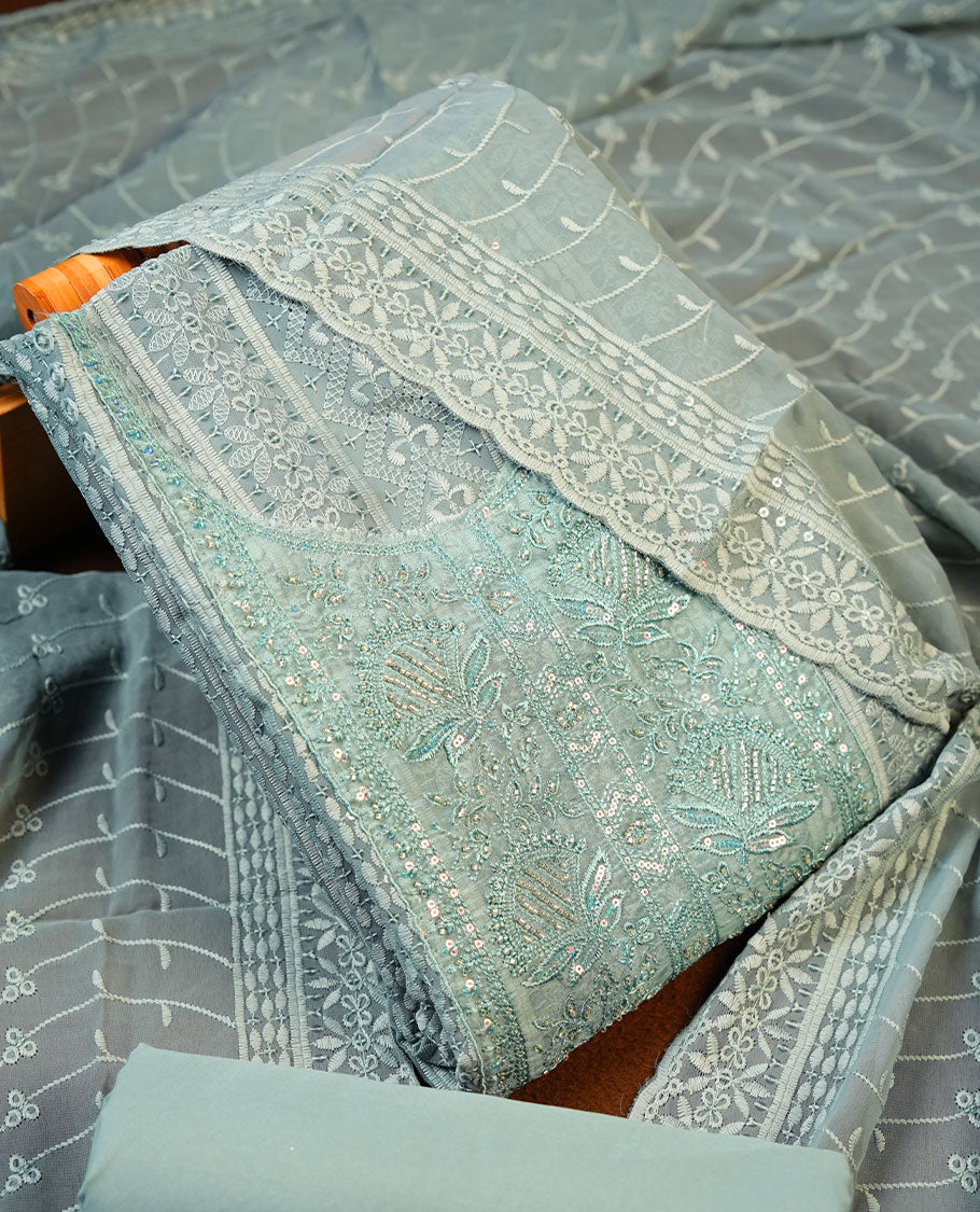 Soft Green colour Churidhar Material featuring Intricate Thread Embroidery with Mirror and Cut Beads Work on the Front Panel, paired with an All Over Embroidered Net Dupatta and Matching Bottom