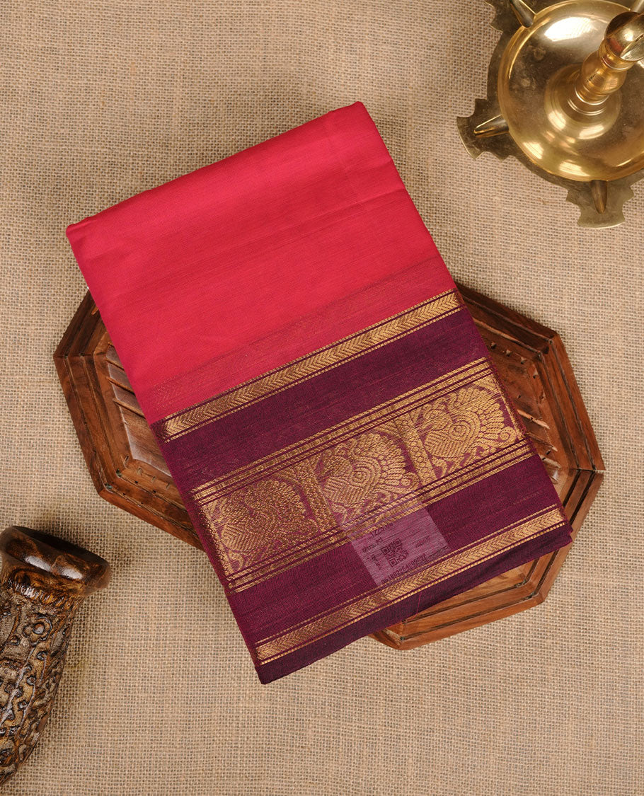 Rani pink colour chettinad cotton saree featuring plain body, contrast burgundy colour with traditional gold zari border paired with matching blouse.
