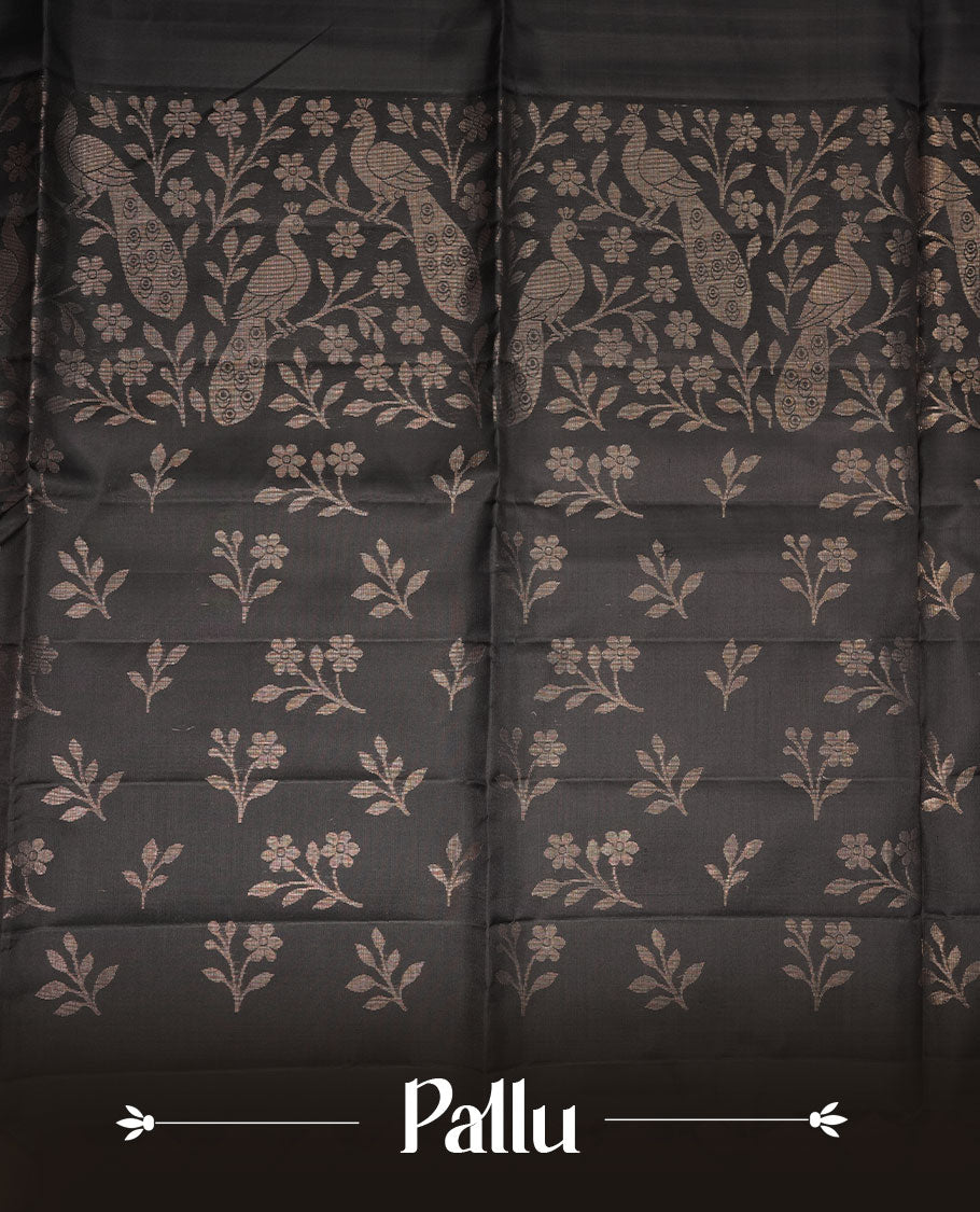 Black colour soft silk saree featuring gold zari peacock motifs on body, complemented by self colour with gold zari border, peacock print on pallu, paired with matching blouse piece.