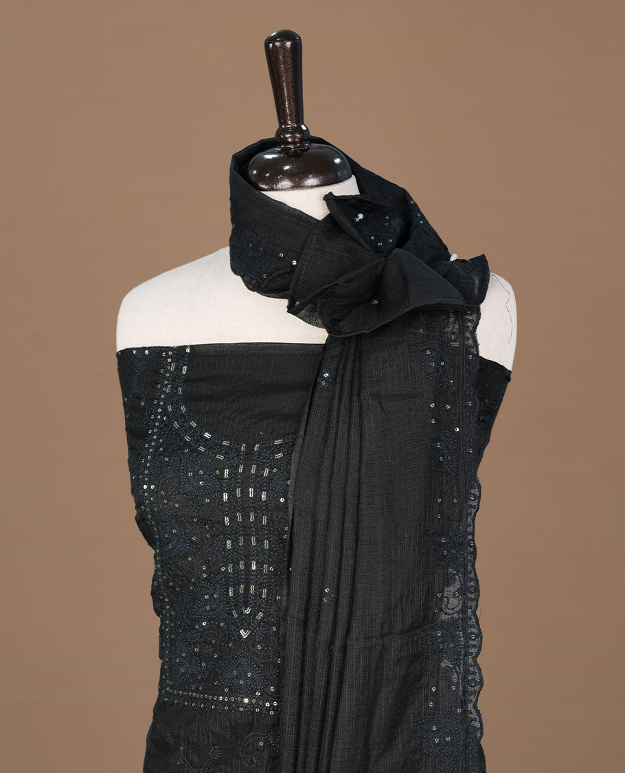 Black colour churidhar material featuring self colour thread and sequins work on body, paired with matching bottom and Dupatta.