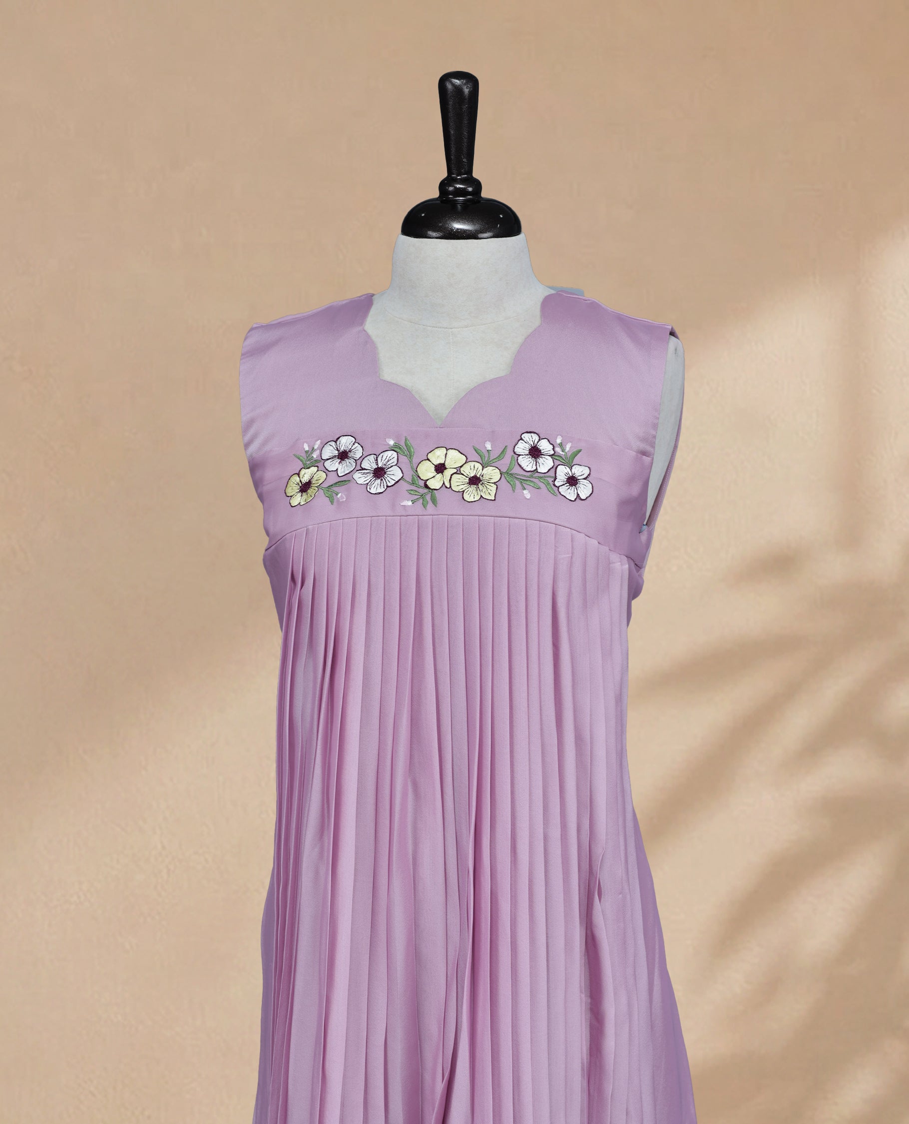 Lavender Coloured Sleeveless Kurti Featuring a Designed Neckline, Floral Embroidery on the Body