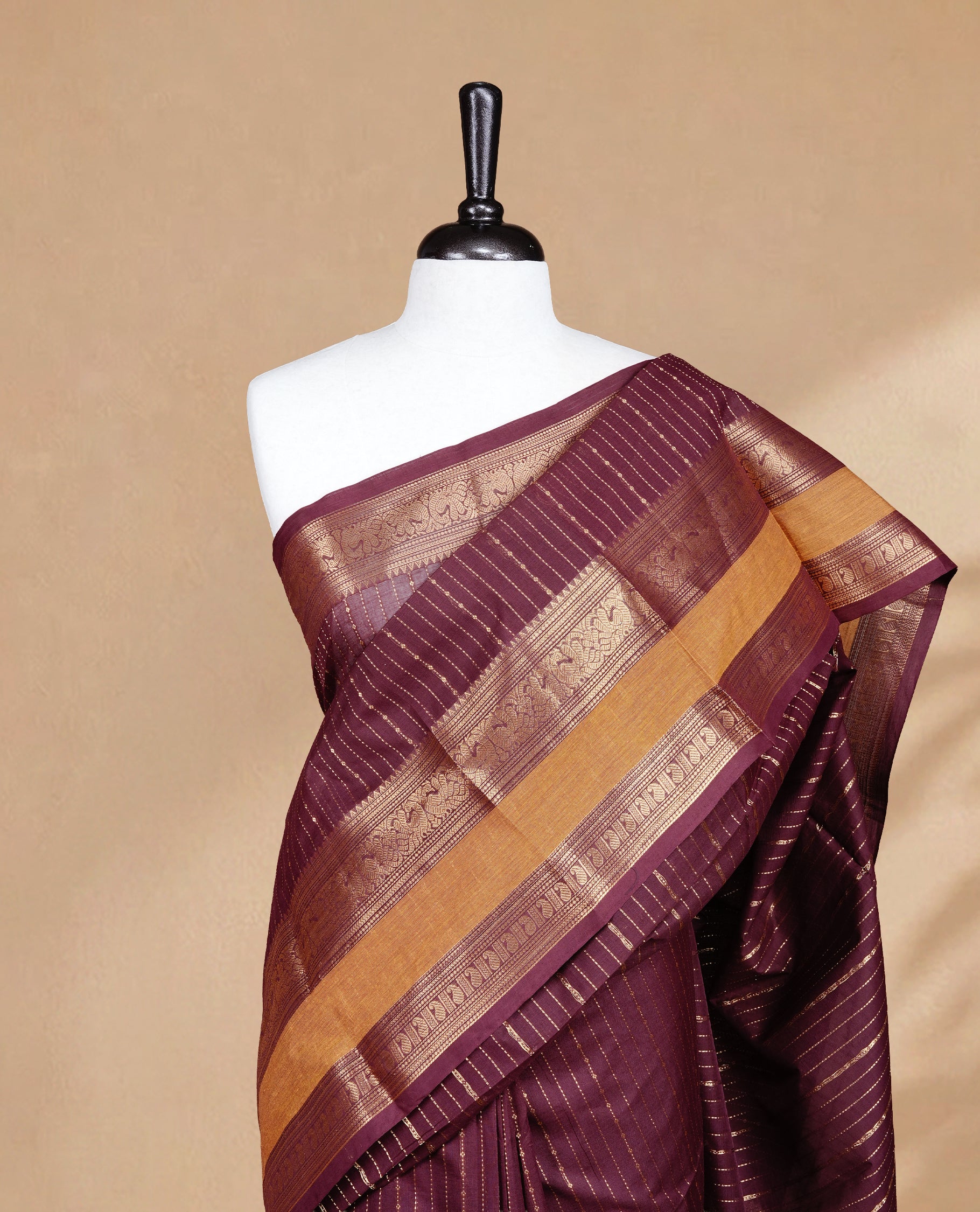 Maroon colour chettinad cotton saree featuring gold zari stripes on body, complemented by Mustard border, paired with matching blouse piece.