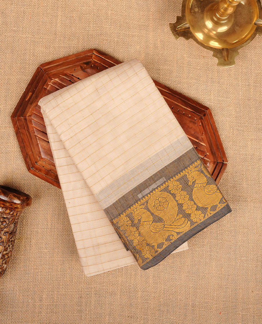 Beige colour chettinad cotton saree featuring gold zari check patterned body, paired with a grey colour traditional gold zari border without blouse.