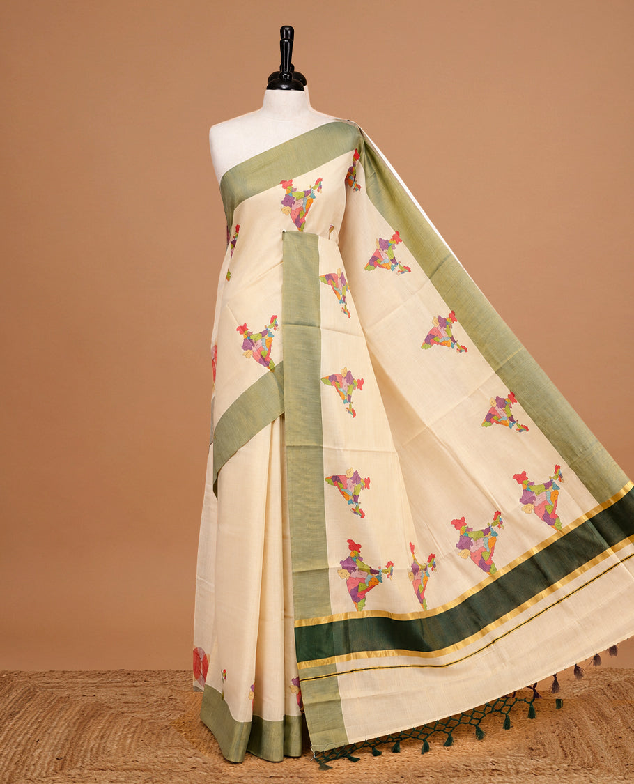 Cream Colour Kerala Saree Featuring Plain Body ,Complemented By A Green Zari With Indian Map Border ,Enhance By A Gold Zari & Green Pallu ,Paired With A Matching Blouse Piece.