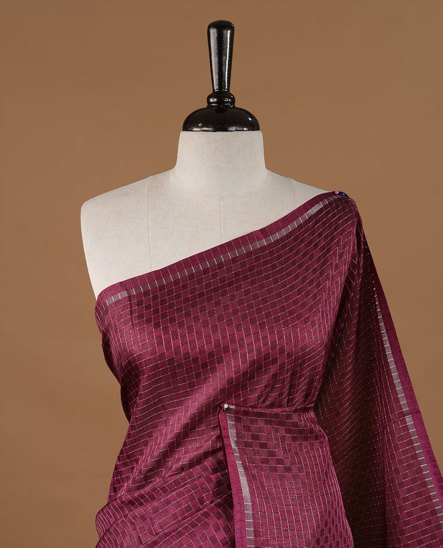 Grape colour Semi Tussar saree featuring an elegant zari fancy check pattern on the body, highlighted with a small border for a refined look. Comes without a blouse piece.