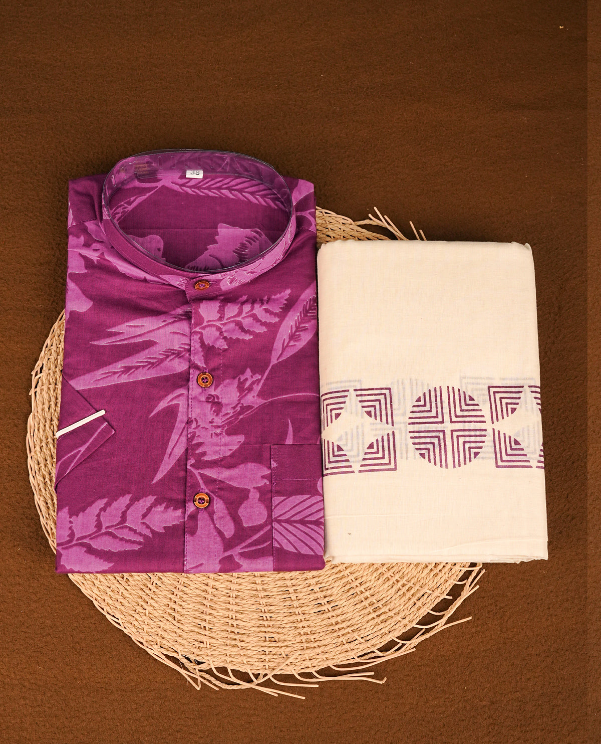 Purple colour shirt featuring a floral pattern printed body, paired with a cream colour double dhoti featuring a printed border.