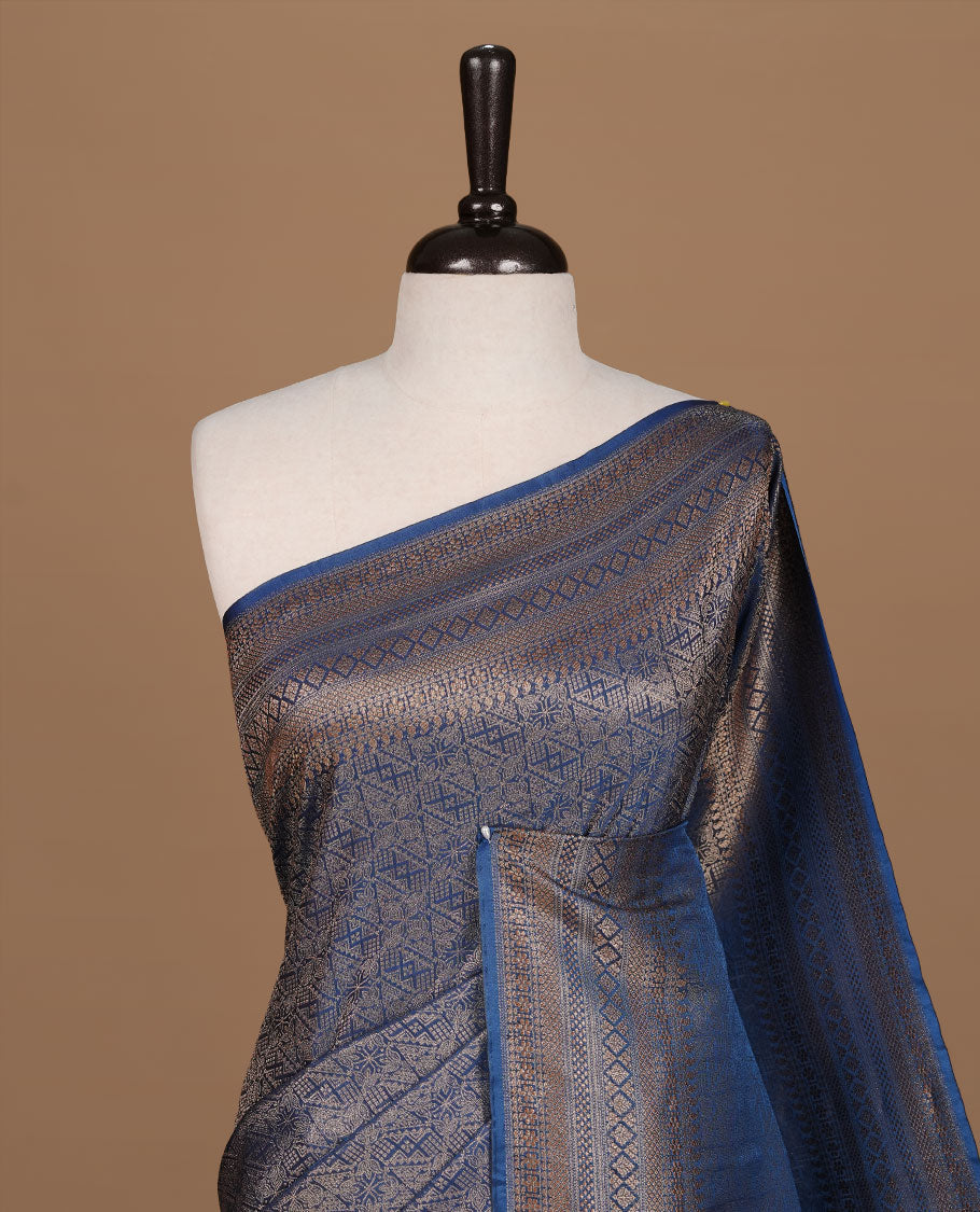 Teal colour semi banaras katan saree featuring Gold zari Pattern across body, complemented by self colour with zari border, paired with matching blouse piece.