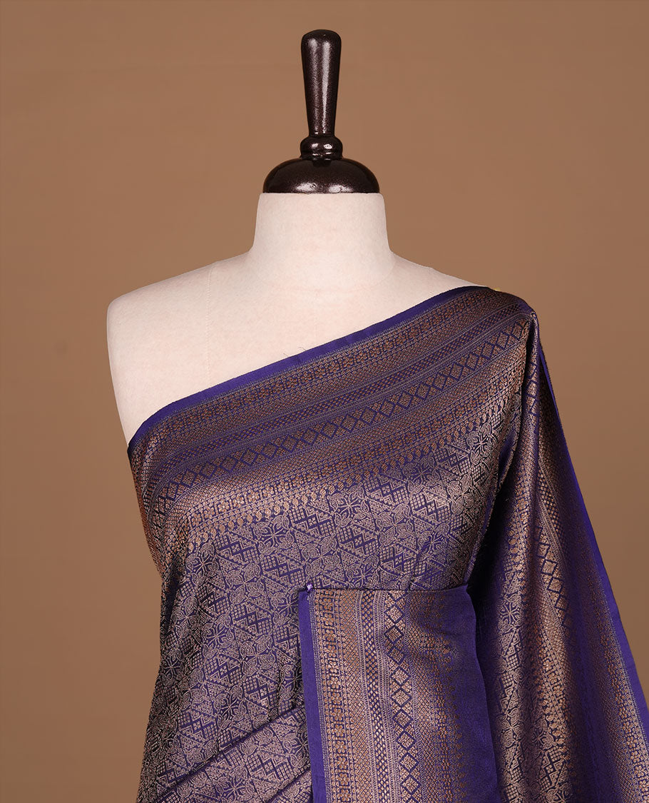 Navy blue colour semi banaras katan saree featuring Gold zari Pattern across body, complemented by self colour with zari border, paired with matching blouse piece.